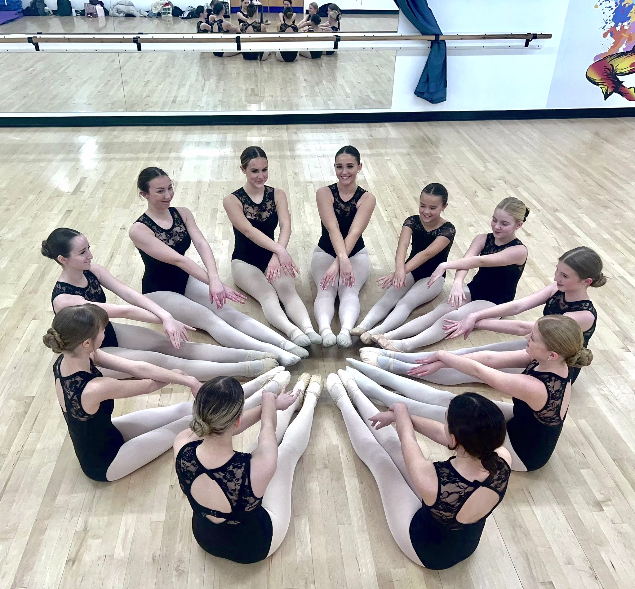Dance students seated in formation